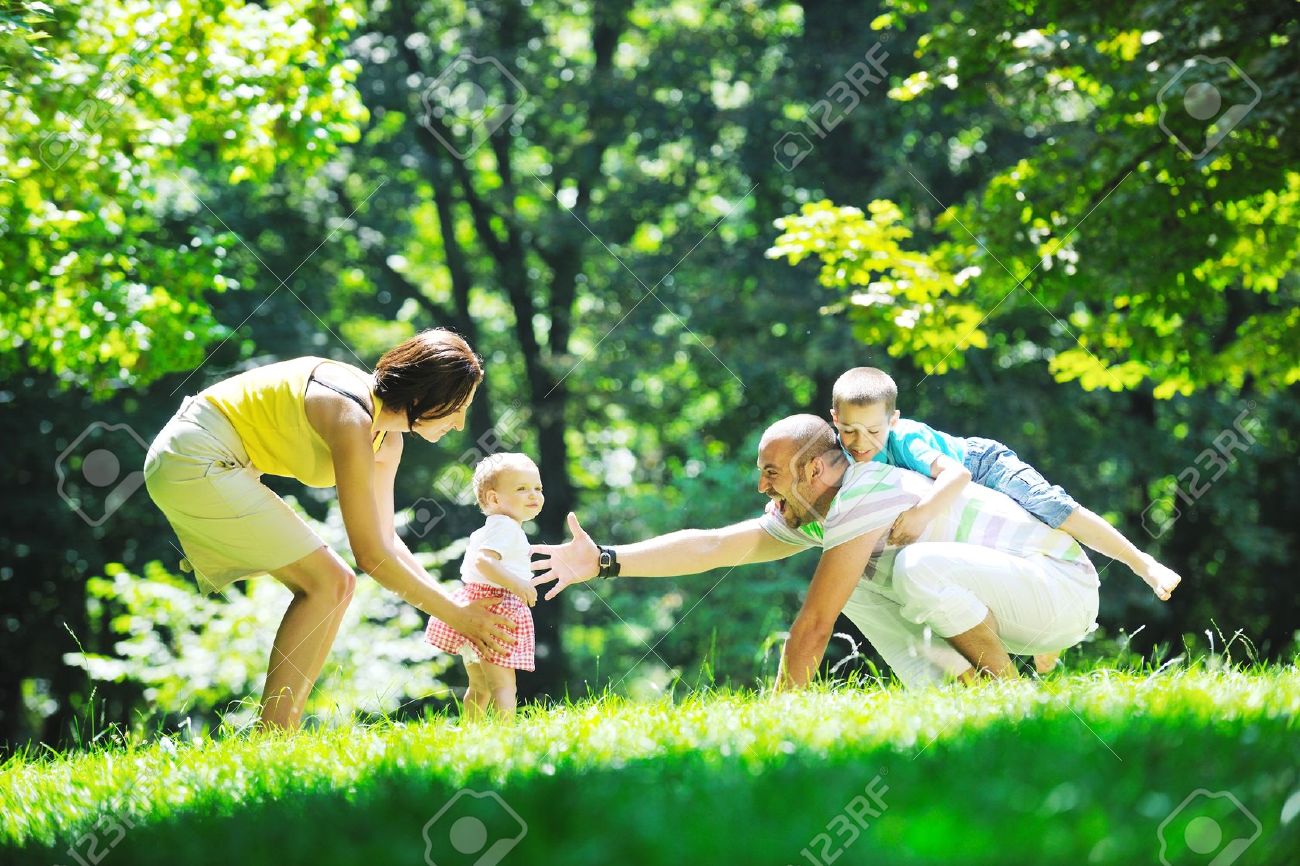 10415270-happy-young-couple-with-their-children-have-fun-at-beautiful-park-outdoor-in-nature-stock-photo